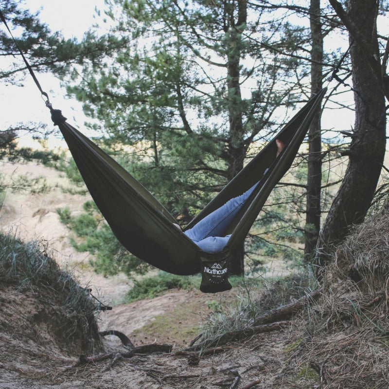 « Hamac Northcore utilisé par un surfeur au milieu de la pinède face aux dunes de sable »